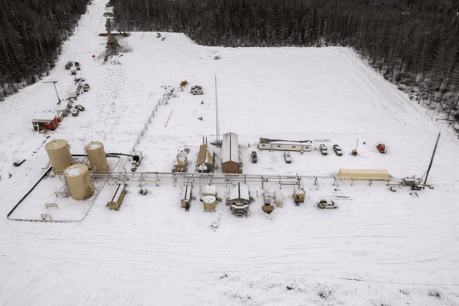 Aerial view of oil & gas facility in snowy field