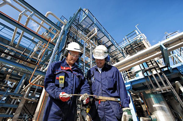 Engineers inspecting oil & gas equipment