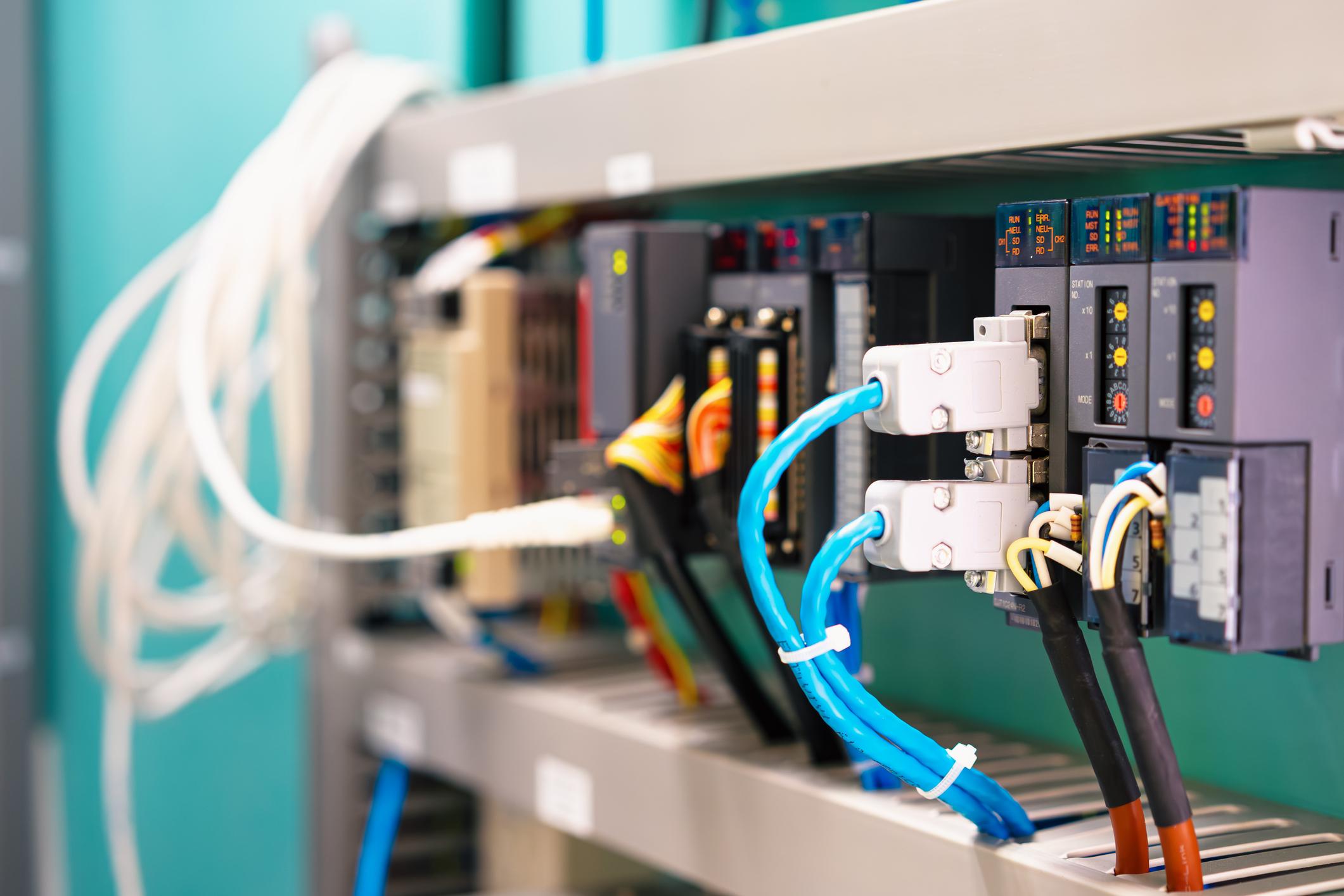 Wiring and I/O modules inside a PLC control panel at an Alberta oil and gas facility